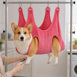 Pink dog grooming hammock for safe nail trimming